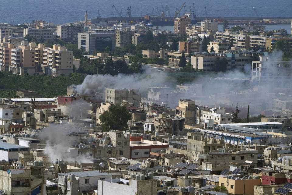 Smoke rises during clashes between members of the Palestinian Fatah group and Islamist militants in the Palestinian refugee camp of Ein el-Hilweh near the southern port city of Sidon, Lebanon, Sunday, Sept. 10, 2023. Islamist factions in Lebanon's largest Palestinian refugee camp said Sunday they will abide by a cease-fire after three days of clashes killed at least five people and left hundreds of families displaced. (AP Photo/Bilal Hussein)