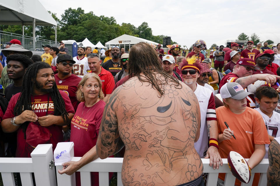 Washington Commanders center Nick Gates signs autographs after a NFL football practice at the team's training facility, Thursday, July 27, 2023 in Ashburn, Va. (AP Photo/Alex Brandon)