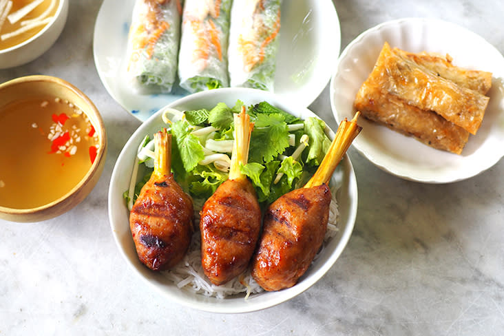 Juicy 'nem lui' or grilled chicken wrapped around lemongrass is paired with fresh vegetables and noodles