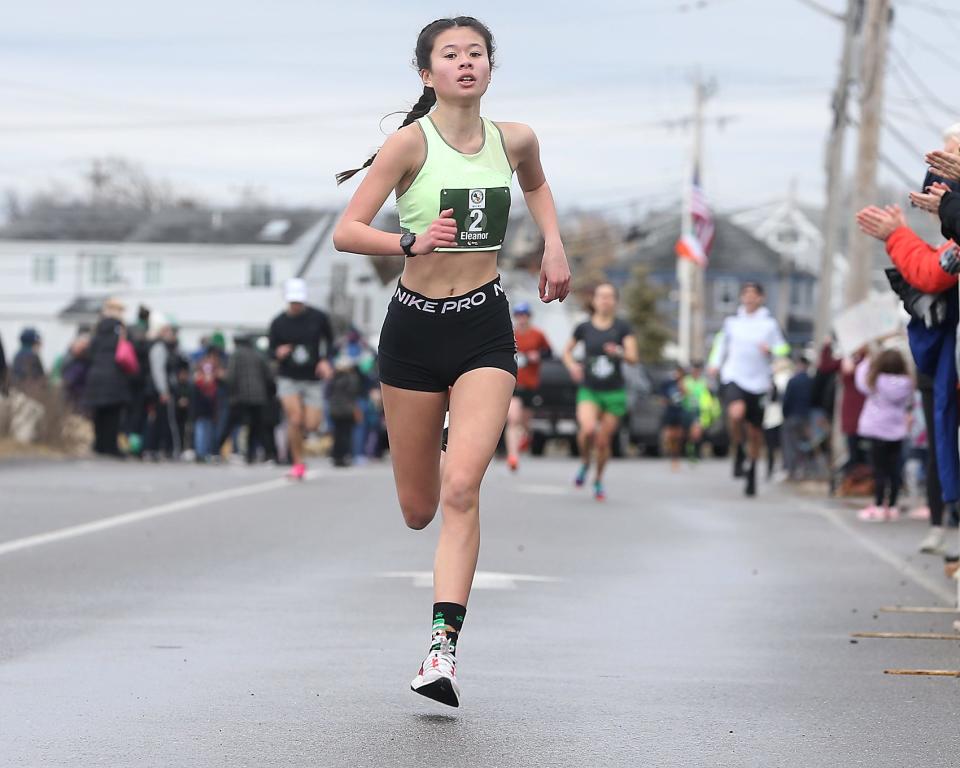 Marshfield High’s Eleanor Angeles-Whitfield approaches the finish line during the 13th annual St. Patrick’s Day 5K in Marshfield on Saturday, March 18, 2023. Over 2800 runners and walkers participated in the 5K that was raising money for the Marshfield Education Foundation. 