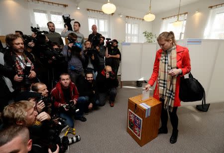 A woman casts her vote in parliamentary elections, as the media await the arrival of the leader of ANO party Andrej Babis, at a polling station in Prague, Czech Republic October 20, 2017. REUTERS/David W Cerny