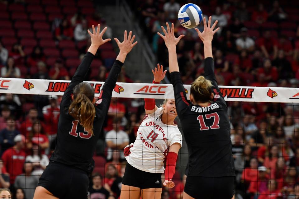 Louisville's Charitie Luper (4) attempts to score past the defense of Stanford's Annabelle Smith (12) and Elia Rubin (13) during the fifth game of the Cardinals' match against Stanford, Sunday, Sept. 17, 2023, in Louisville Ky. Louisville lost to Stanford 3-2