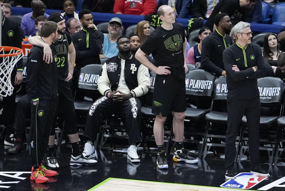 New Orleans Pelicans forward Zion Williamson, in street clothes due to an injury, watches as he sits on the bench in the waning moments of the second half of Game 4 of an NBA basketball first-round playoff series against the Oklahoma City Thunder in New Orleans, Monday, April 29, 2024. The Thunder won 97-89 to sweep the series and advance to the second round. (AP Photo/Gerald Herbert)