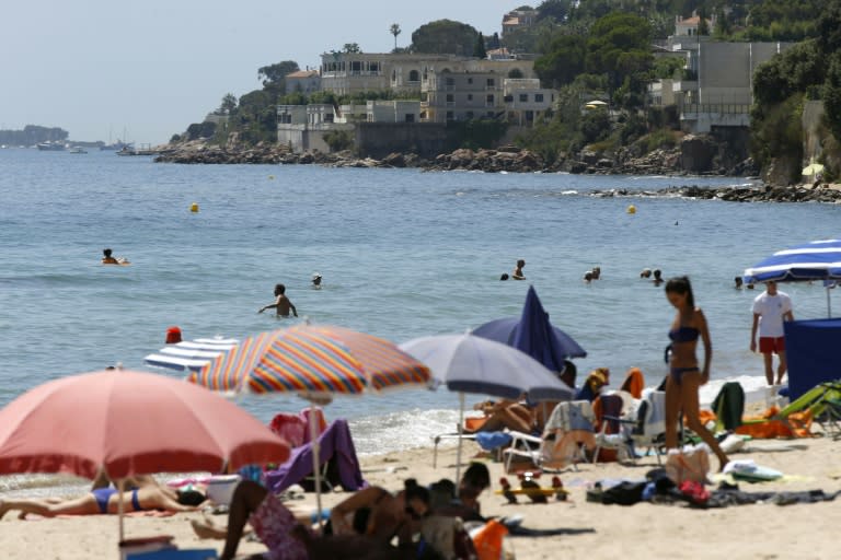 People enjoy a day out at the beach near the villa of the Saudi king in Vallauris Golfe-Juan, southeastern France, on July 26, 2015