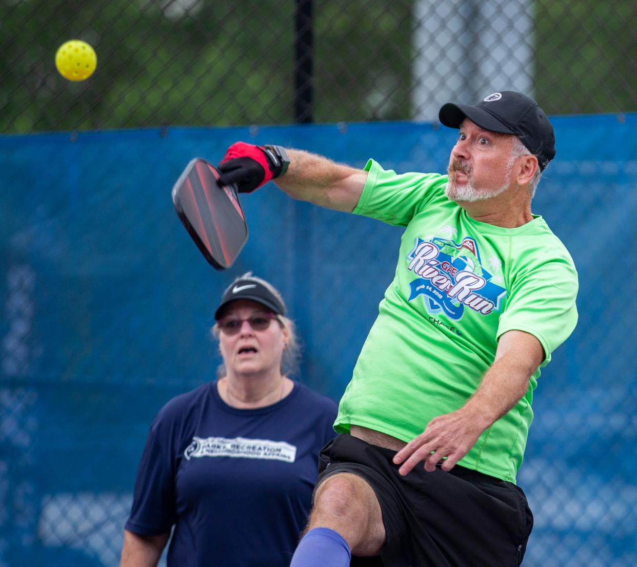 Ryan Burk hits the ball back to his opponents as he and his partner compete in the mixed doubles pickleball tournament at Tom Brown Park during the 12th Annual Capital City Senior Games Thursday, May 6, 2021.