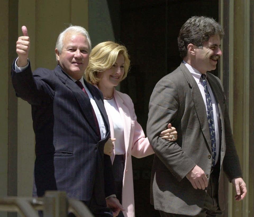 FILE - In this April 19, 2000, file photo, former Louisiana Gov. Edwin Edwards, left, joined by his wife Candy and his defense attorney Daniel Small, gives the thumbs up sign as they leave the federal courthouse in Baton Rouge, La. Edwin Washington Edwards, the high-living four-term governor whose three-decade dominance of Louisiana politics was all but overshadowed by scandal and an eight-year federal prison stretch, died Monday, July 12, 2021 . He was 93. Edwards died of respiratory problems with family and friends by his bedside, family spokesman Leo Honeycutt said. He had suffered bouts of ill health in recent years and entered hospice care this month at his home in Gonzales, near the Louisiana capital. (AP Photo/Bill Haber, File)