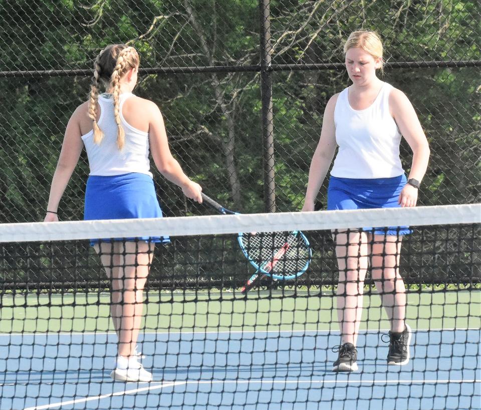 The number two doubles team of Alex Sartelle and Maddi Dill congratulate each other on a point. The pair won their sectional opening match against South Vermillion.