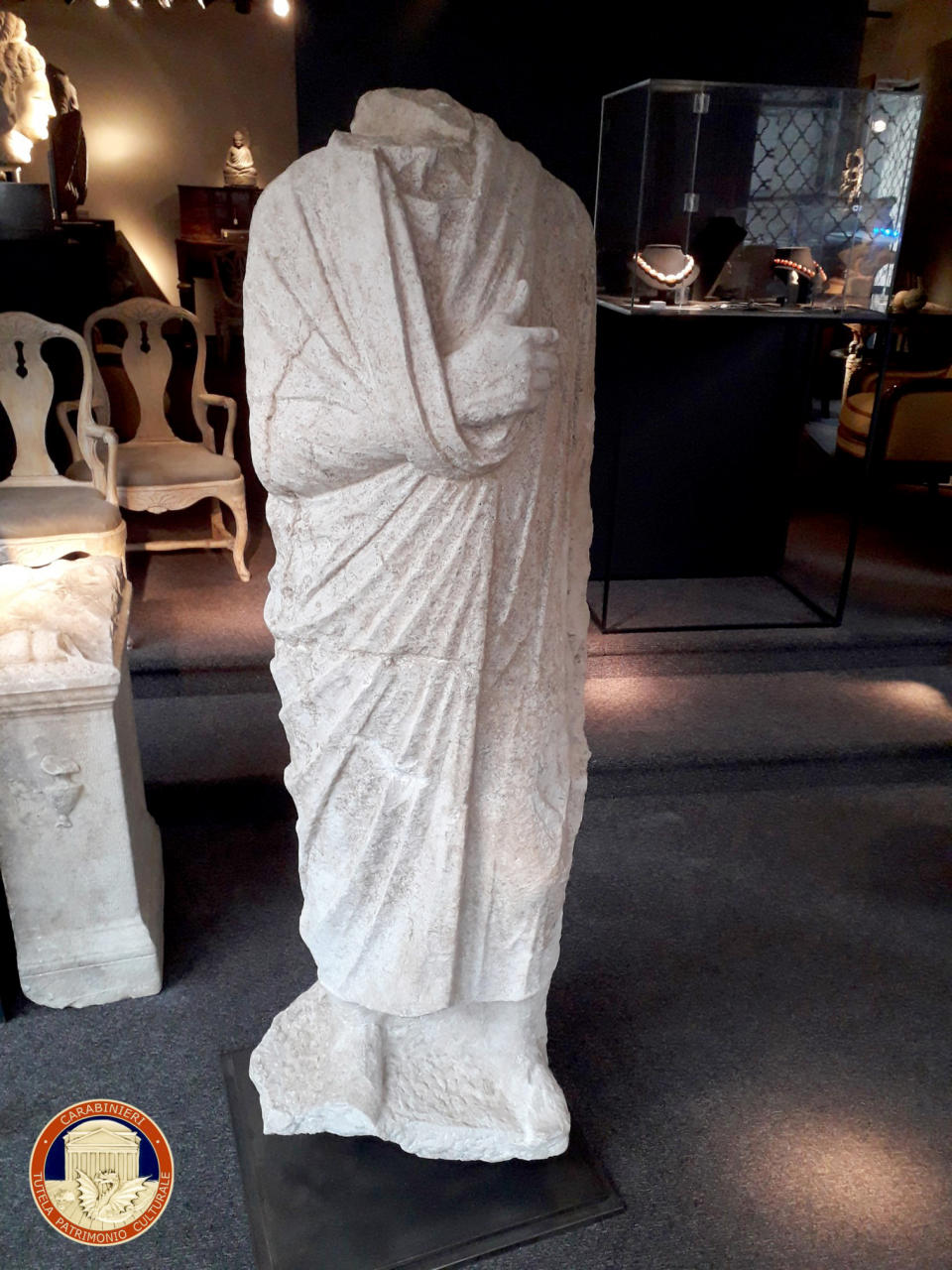 This image released on Monday, April 12, 2021 by the Carabinieri (Italian paramilitary police) art squad’s archaeological unit, shows a headless Roman statue wearing a draped toga recovered in Brussels on Wednesday, Feb. 3, 2021. Italian police say they have recovered a 1st century Roman statue that was stolen from an archaeological site in 2011 and found in a Belgian antiques shop by two off-duty Italian art squad police officers. The Carabinieri art squad said Monday that an Italian businessman who used a Spanish pseudonym has been referred to prosecutors for further investigation into allegations he received and then exported the statue abroad. The statue has been valued at 100,000 euro. (Carabinieri via AP)