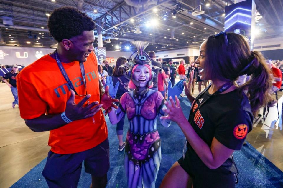 University of Miami fans Lyonell Gaines and Michaela Stoudemire interact with Tanya Colbert in character before the start of the Men’s Basketball Championship National Semifinal between Florida Atlantic Owls against the San Diego State Aztecs at NRG Stadium in Houston, Texas on Saturday, April 1, 2023.