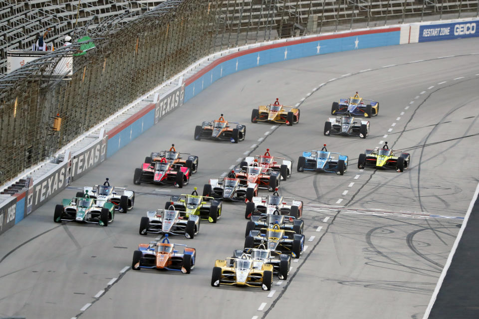 The field gets a green flag for the start of an IndyCar auto race at Texas Motor Speedway in Fort Worth, Texas, Saturday, June 6, 2020. (AP Photo/Tony Gutierrez)