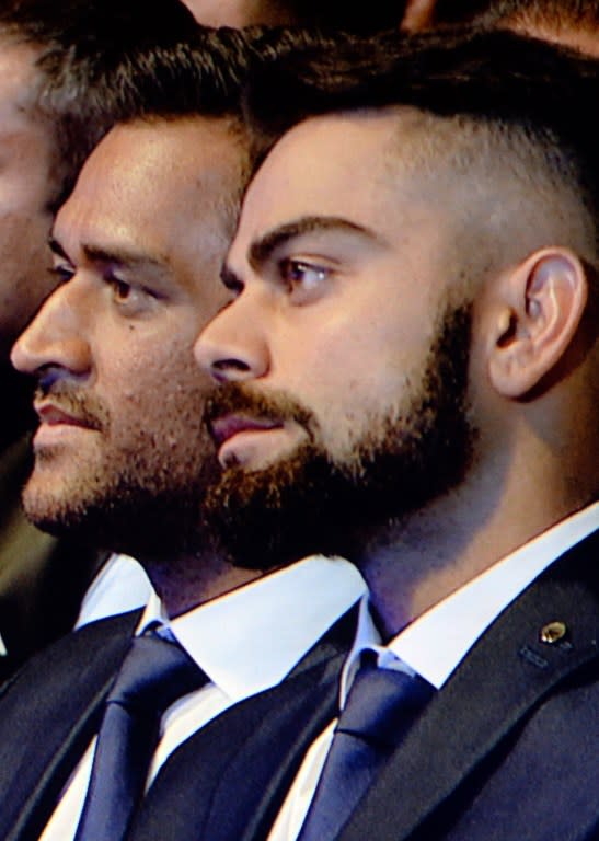 <p>Indian cricketers Mahendra Singh Dhoni (L) and Virat Kohli are seen on a giant screen at the The BCCI Annual Awards, 2014-15 in Mumbai on January 5, 2016. The BCCI Annual Awards, held annually is to honour achievements of Indian cricketers in domestic and international level. </p>