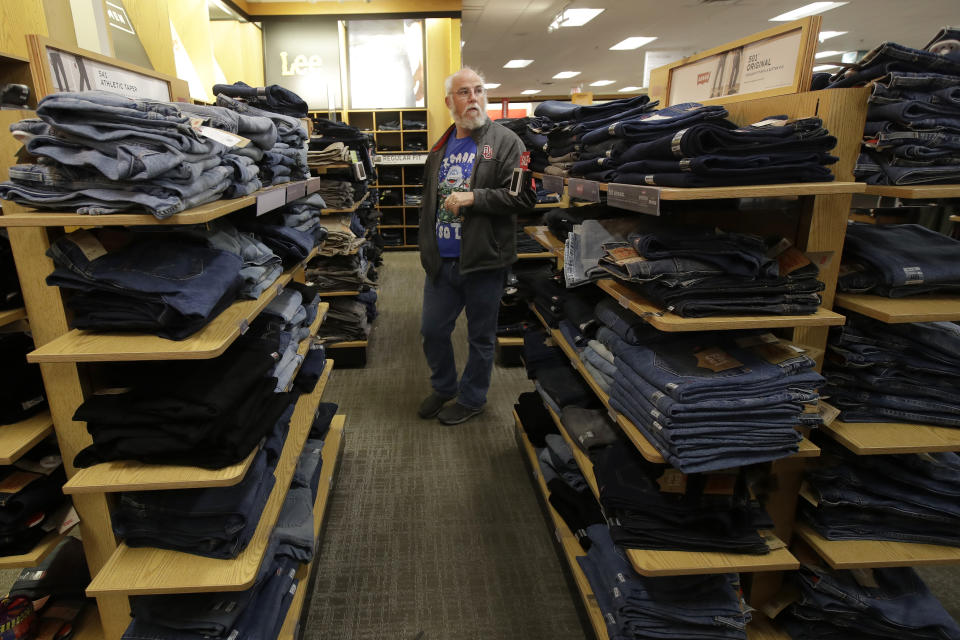 FILE - In this Nov. 29, 2019, file photo Tim Simpson shops at a Kohl's store in Colma, Calif. On Friday, Dec. 13, the Commerce Department releases U.S. retail sales data for November. (AP Photo/Jeff Chiu, File)