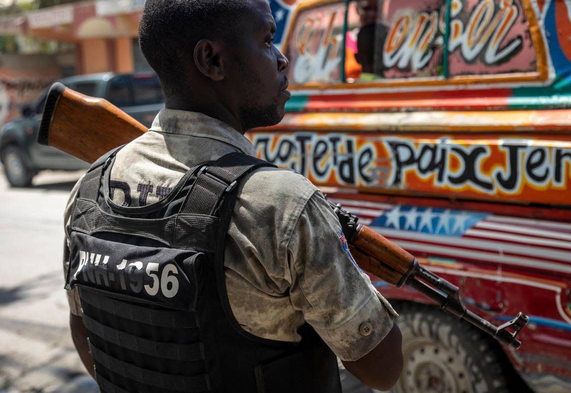 A policeman keeps an eye on passing vehicles at a checkpoint on the streets in Port-au-Prince on June 23, 2022.