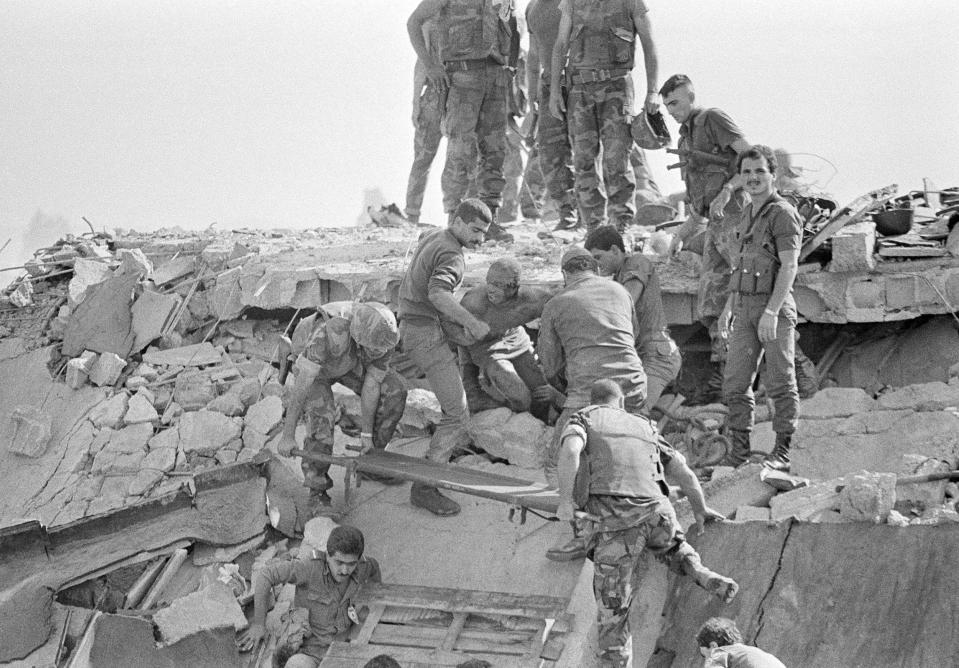 A U.S. Marine looks around as he is pulled from the wreckage of the marine headquarters near Beirut airport.