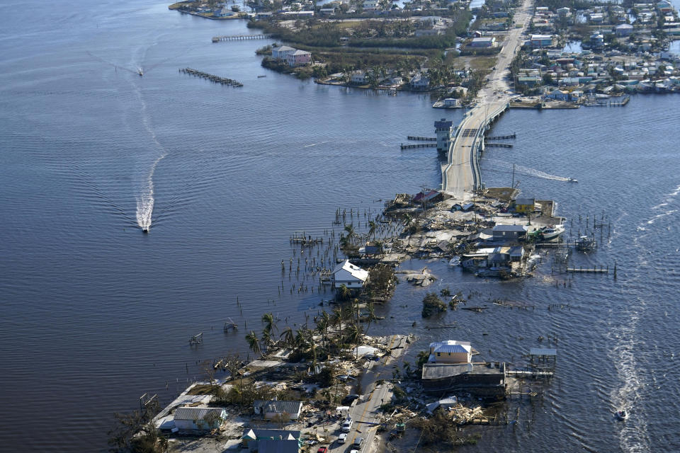 FILE - The bridge leading from Fort Myers to Pine Island, Fla., is heavily damaged in the aftermath of Hurricane Ian, Oct. 1, 2022. Hurricane Ian briefly reached Category 5 status with 161 mph (259 kph) winds over open water before striking southwestern Florida as a slightly weaker 150 mph (241 kph) storm last September, eventually causing over $112 billion in damage in the U.S. and more than 150 deaths directly or indirectly, the National Oceanic and Atmospheric Administration reported Monday, April 3, 2023. (AP Photo/Gerald Herbert, File)