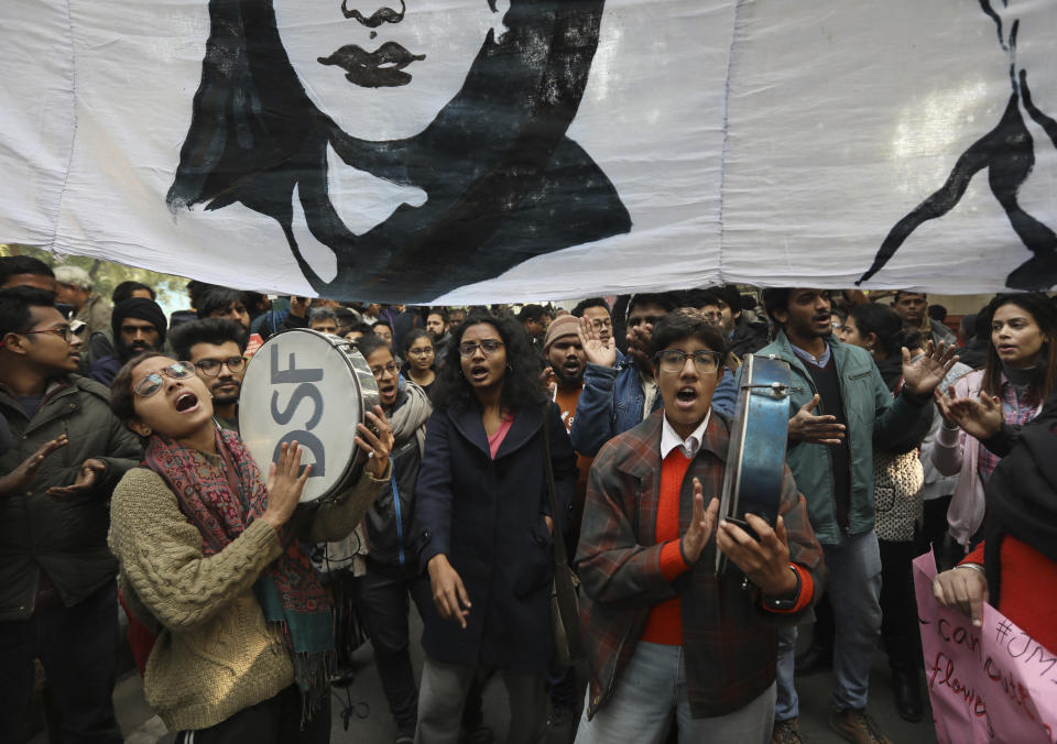 Students shout slogans against government during a protest against a new citizenship law in New Delhi, India, Tuesday, Dec. 24, 2019. Hundreds of students marched Tuesday through the streets of New Delhi to Jantar Mantar, an area designated for protests near Parliament, against the new citizenship law, that allows Hindus, Christians and other religious minorities who are in India illegally to become citizens if they can show they were persecuted because of their religion in Muslim-majority Bangladesh, Pakistan and Afghanistan. It does not apply to Muslims. (AP Photo/Manish Swarup)
