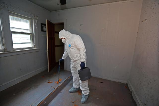 Kelly Jackson, owner and president of AJ Development Group test the moisture levels while doing an assessment for mold in a building in the 5400 block of North 41st Street. The house was damaged due to an electrical fire. Over the course of time mold began to develop inside the interior structure that was left vacant and compromised to the elements.
