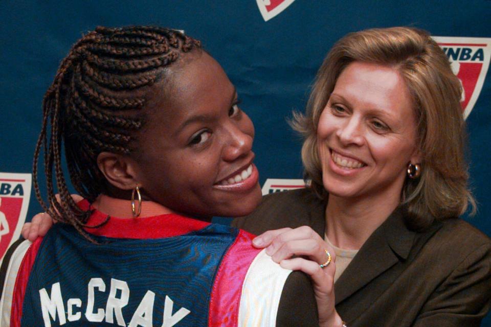 Nikki McCray models a Women's National Basketball Association jersey with WNBA President Val Ackerman at the league's headquarters in New York Tuesday, Sept. 16, 1997. Two-time Olympic gold medalist and former ABL MVP Nikki McCray-Penson died on July 7, 2023. She was 51.