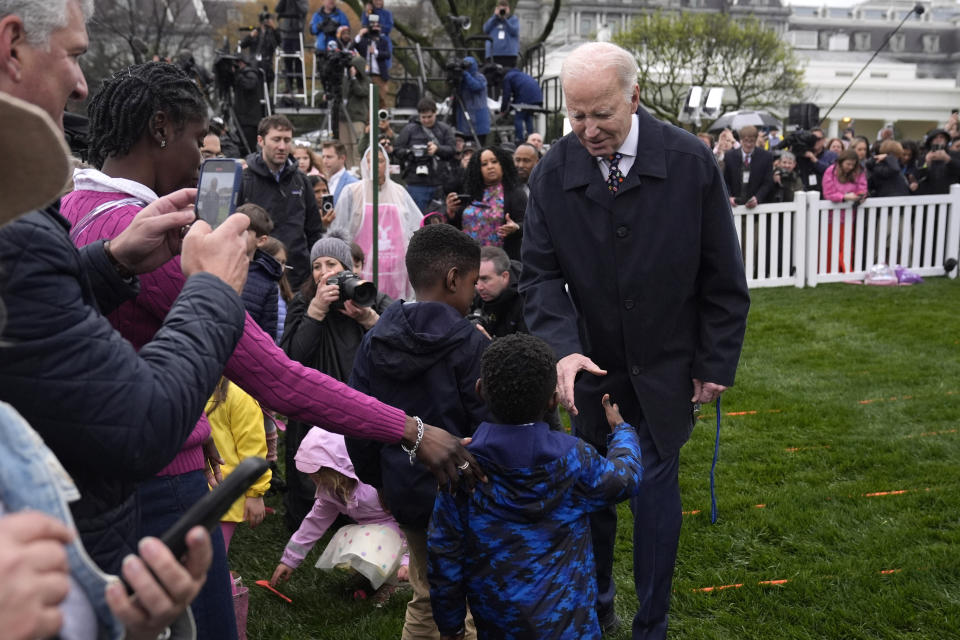 President Joe Biden, right, greets children at the White House Easter Egg Roll on the South Lawn of the White House, Monday, April 1, 2024, in Washington. (AP Photo/Evan Vucci)