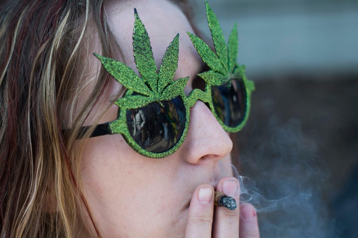 Rachel Brown of Grand Haven smokes during Hash Bash on Saturday, April 1, 2017 at the University of Michigan in Ann Arbor. The event brought supporters of marijuana together with shouts of "Free the weed!"