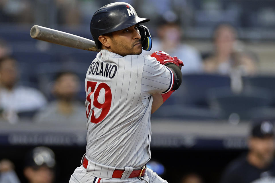 FILE - Minnesota Twins' Donovan Solano hits a run scoring double against the New York Yankees during the first inning of a baseball game Thursday, April 13, 2023, in New York. TeriAnn Reynolds and her family hosted players for more than a decade, including a handful of eventual big leaguers like David Peralta and Donovan Solano. She said it was a wonderful experience — outside of a few “cantankerous kids" — and is sad that more families won't be able to experience it. Host families have officially been sidelined. (AP Photo/Adam Hunger, File)