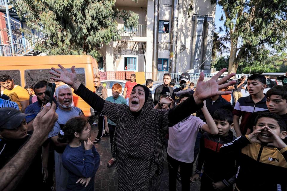 PHOTO: A woman reacts as people gather at the site of the Ahli Arab hospital in central Gaza, Oct. 18, 2023. (AFP via Getty Images)