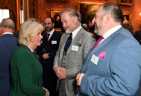 Britain's Camilla, the Duchess of Cornwall speaks with actor Owen Teale and singer Wynne Evans at a reception to mark the fiftieth anniversary of the investiture of the Prince of Wales at Buckingham Palace in London, Britain March 5, 2019. Dominic Lipinski/Pool via REUTERS