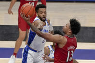 Louisville's David Johnson (13) shoots as Pittsburgh's Terrell Brown (21) defends during the second half of an NCAA college basketball game, Tuesday, Dec. 22, 2020, in Pittsburgh. (AP Photo/Keith Srakocic)