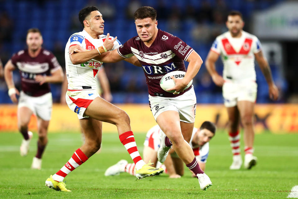 GOLD COAST, AUSTRALIA - JULY 16:  Josh Schuster of the Sea Eagles is tackled by Tyrell Sloan of the Dragons during the round 18 NRL match between the Manly Sea Eagles and the St George Illawarra Dragons at Cbus Super Stadium, on July 16, 2021, in Gold Coast, Australia. (Photo by Chris Hyde/Getty Images)