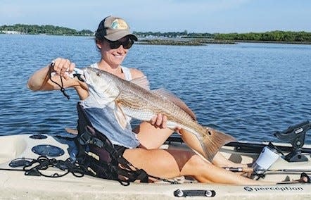 Bill Clark sent in this shot of Sarah Clark with a catch-and-release redfish caught from her kayak.