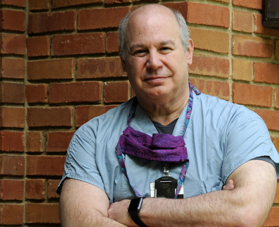 Dr. Michael Saag, who survived COVID-19 and now treats patients with the disease, poses for a portrait at his home in Mountain Brook, Ala., on Friday, July 10, 2020. Saag, who specializes in infectious diseases, is getting increasingly frustrated as many in the public flout measures meant to prevent the spread of the illness caused by the new coronavirus. (AP Photo/Jay Reeves)