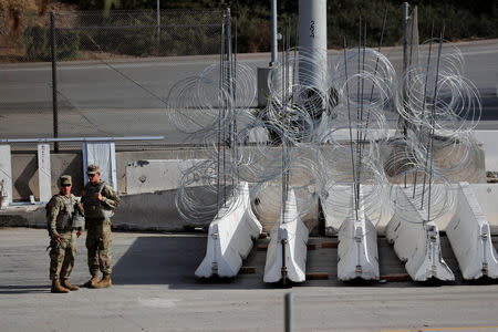 U.S. Army MPs stand by concertina wire and barricades at the U.S. Mexico border as they prepare for the arrival of a caravan of migrants at the San Ysidro border crossing in San Diego, California, U.S., November 13, 2018. REUTERS/Mike Blake