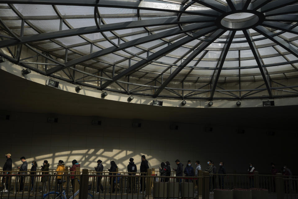 People stand in line for their routine COVID-19 tests at a coronavirus testing site at a tunnel in the central business district of Beijing, Wednesday, Nov. 16, 2022. Chinese authorities locked down a major university in Beijing on Wednesday after finding one COVID-19 case as they stick to a "zero-COVID" approach despite growing public discontent. (AP Photo/Andy Wong)