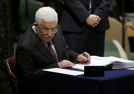 Palestinian President Mahmoud Abbas signs the Paris Agreement on climate change at the United Nations Headquarters in Manhattan, New York, U.S., April 22, 2016. REUTERS/Carlo Allegri