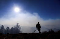 Firefighter Josh Petrell monitors the Kincade Fire burning near Healdsburg, Calif., on Tuesday, Oct. 29, 2019. The overall weather picture in northern areas is improving as powerful, dry winds bring extreme fire weather to Southern California. (AP Photo/Noah Berger)