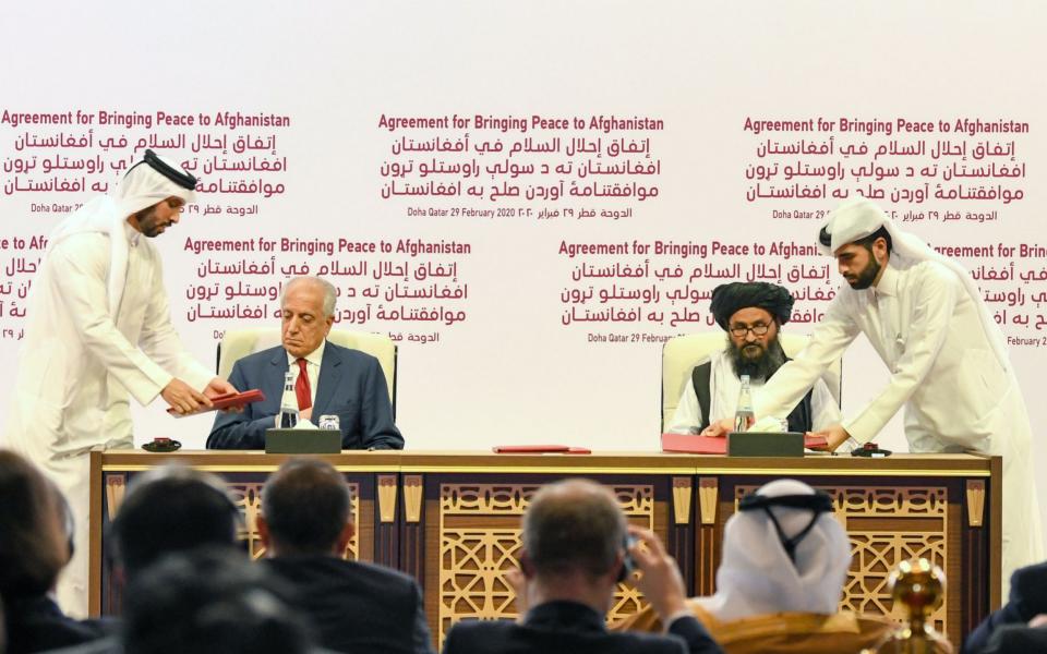  US Special Representative for Afghanistan Reconciliation Zalmay Khalilzad (2-L) and Taliban co-founder Mullah Abdul Ghani Baradar (2-R) sign the US-Taliban peace agreement during a ceremony in Doha, Qatar, 29 February 2020. The United States and the Taliban on 29 February penned a historic Agreement to Bringing Peace to Afghanistan which paves the way for the withdrawal of US troops and intra-Afghan negotiations. US and Taliban sign peace deal in Qatar, Doha - STRINGER/EPA-EFE/REX
