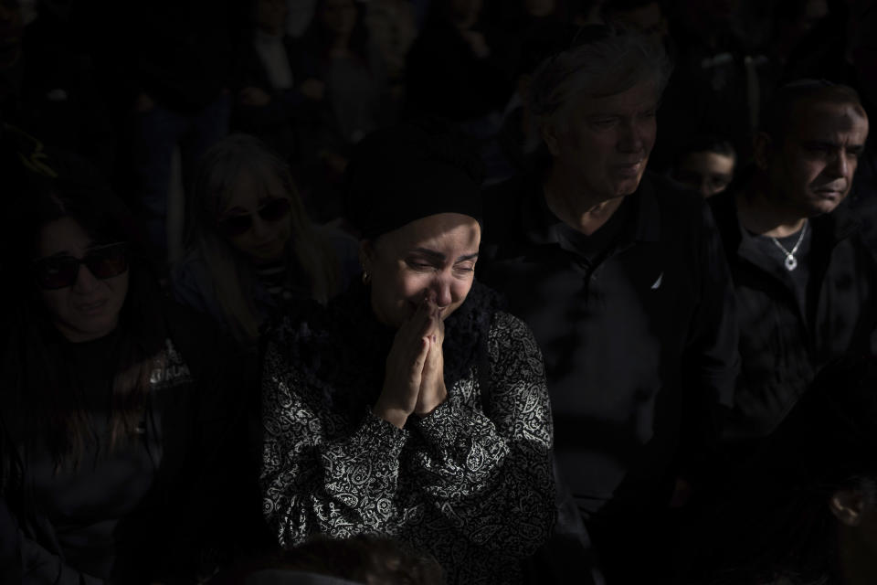 Family and friends of Israeli soldier Lt. Yaacov Elian mourn over his grave during his funeral at Kiryat Shaul cemetery in Tel Aviv, Israel, Friday, Dec. 22, 2023. Elian, 20, was killed during Israel's ground operation in the Gaza Strip, where it has been battling Palestinian militants in the war ignited by Hamas' Oct. 7 attack into Israel. (AP Photo/Oded Balilty)