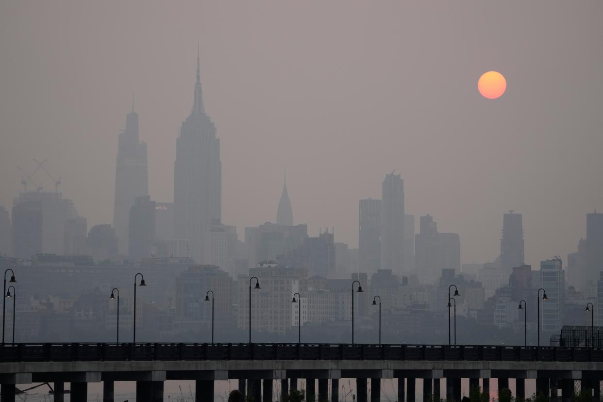 The sun rises over a hazy New York City skyline as seen from Jersey City, N.J., Wednesday, June 7, 2023. Intense Canadian wildfires are blanketing the northeastern U.S. in a dystopian haze, turning the air acrid, the sky yellowish gray and prompting warnings for vulnerable populations to stay inside.