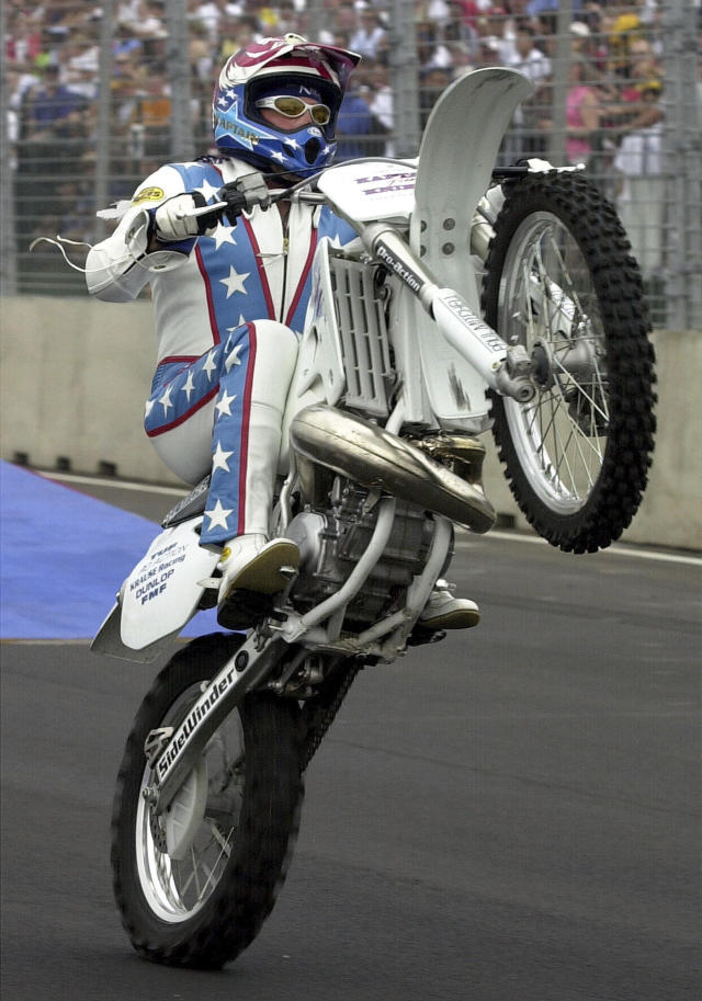FILE - Motorcycle daredevil Robbie Knievel performs before the start of the Cadillac Grand Prix car race in Washington on July 21, 2002 . (AP Photo/Kenneth Lambert, File)