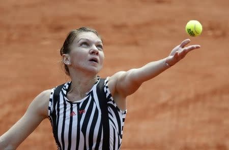 Halep serves. REUTERS/Jacky Naegelen