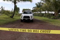 <p>A police office blocks a road near lava fissure 17 after it erupted on May 13 2018 near Pahoa, Hawaii. The new fissure emitting steam and lava spatter spurred Hawaii officials to call for more evacuations on Sunday as residents braced for an expected eruption from the Kilauea volcano. (Photo: Caleb Jones/AP) </p>