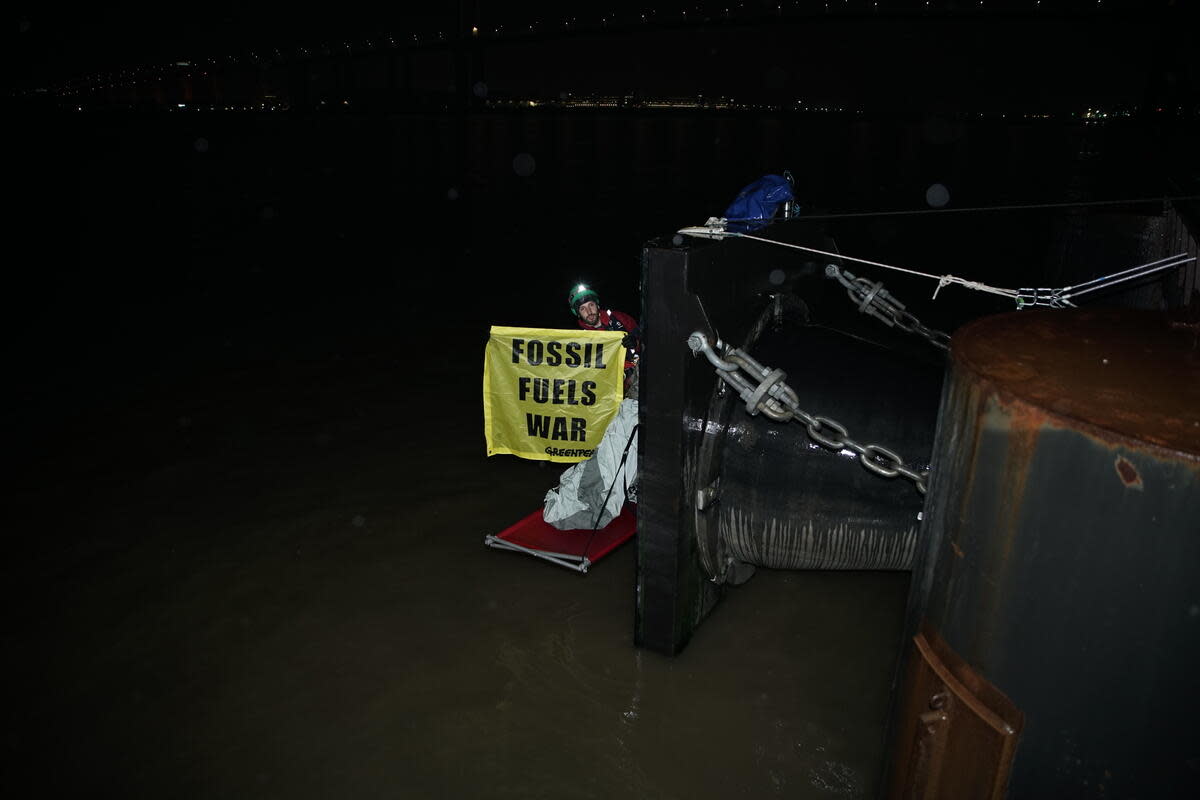 Greenpeace climbers block a tanker carrying 33,000 tonnes of Russian diesel to the UK at Navigator Terminals in Essex)