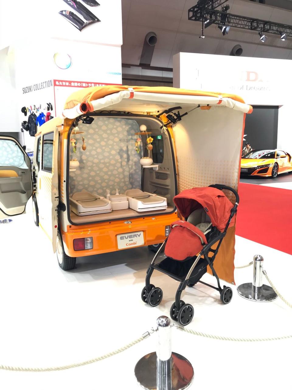 <p>This weird van looks as if it drove through <em>That '70s Auto Show</em> before it arrived in Tokyo. This is Suzuki's commercial van turned baby station. Sure, the <a href="https://www.caranddriver.com/honda/odyssey" rel="nofollow noopener" target="_blank" data-ylk="slk:Honda Odyssey;elm:context_link;itc:0;sec:content-canvas" class="link ">Honda Odyssey</a> has a vacuum, but the <a href="https://www.caranddriver.com/news/a29561529/suzuki-every-go-anywhere-baby-room-concept-photos-info/" rel="nofollow noopener" target="_blank" data-ylk="slk:Suzuki Every Go Anywhere Baby Room;elm:context_link;itc:0;sec:content-canvas" class="link ">Suzuki Every Go Anywhere Baby Room</a> is equipped with dual diaper-changing beds, wipes dispensers, bamboo flooring, and curtains. Suzuki says the van is meant to offer a safe and private place for babies and breast-feeding mothers at outdoor events.</p>