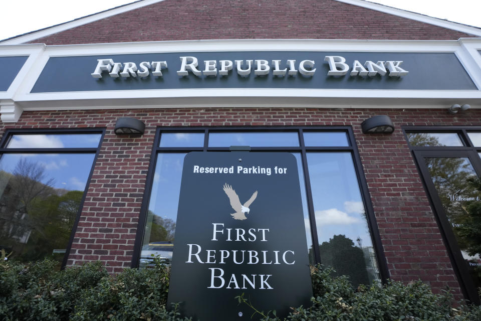 FILE - First Republic Bank signs and logos are displayed on a branch on April 26, 2023, in Wellesley, Mass. Regulators continued their search for a solution to First Republic Bank’s woes over the weekend before stock markets were set to open Monday, May 1. (AP Photo/Steven Senne, File)