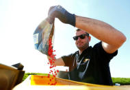 An employee of the "Poschinger Bray'sche Gueterverwaltung" company fills maize into a tractor equipped with an iTC receiver (used for parallel driving) at a field in Irlbach near Deggendorf, Germany, April 21, 2016. REUTERS/Michaela Rehle