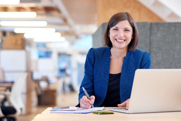 Smiling woman at a desk.