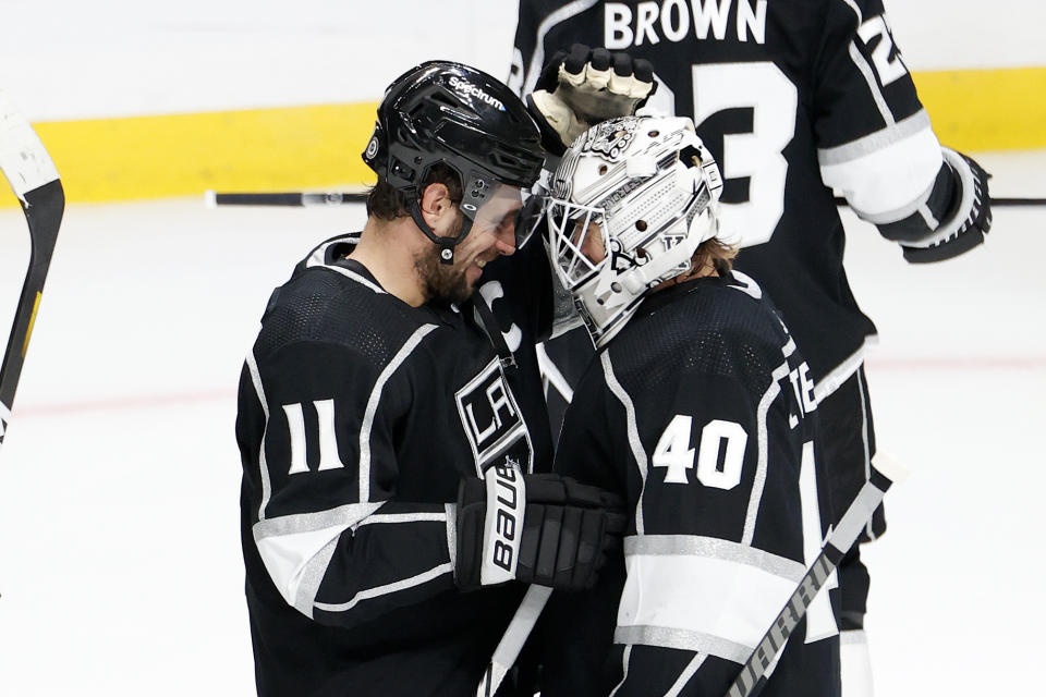 Los Angeles Kings forward Anze Kopitar (11) and goalie Calvin Petersen (40) celebrate after the team's 6-2 win over the Vegas Golden Knights in an NHL hockey game Thursday, Oct. 14, 2021, in Los Angeles. (AP Photo/Ringo H.W. Chiu)