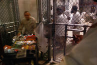 GUANTANAMO BAY, CUBA - OCTOBER 27: (EDITORS NOTE: Image has been reviewed by U.S. Military prior to transmission.) A military librarian brings out books read by detainees inside the U.S. military prison for "enemy combatants" on October 27, 2009 in Guantanamo Bay, Cuba. Although U.S. President Barack Obama pledged in his first executive order last January to close the infamous prison within a year's time, the government has been struggling to try the accused terrorists and to transfer them out ahead of the deadline. Military officials at the prison point to improved living standards and state of the art medical treatment available to detainees, but the facility's international reputation remains tied to the "enhanced interrogation techniques" such as waterboarding employed under the Bush administration. (Photo by John Moore/Getty Images)