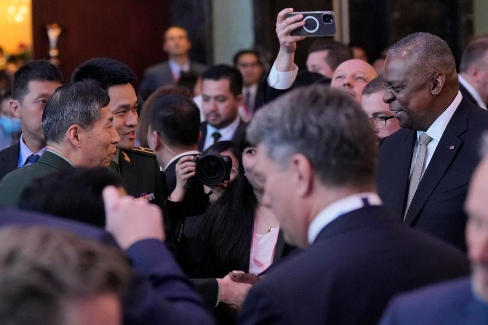 US defence secretary Lloyd Austin (right) shake hands with China defense minister Li Shangfu (left) during the opening dinner during Shangri La Summit (AP)