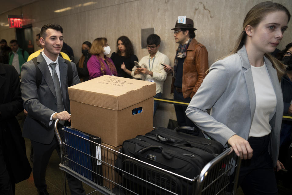 A box bearing the words "The Trump Corp," "The Trump Payroll Corp," and "Allen Weisselberg," is brought to a courtroom as lawyers arrive to criminal court, Monday, Oct. 31, 2022, in New York. The Trump Organization is on trial this week for criminal tax fraud. (AP Photo/John Minchillo)